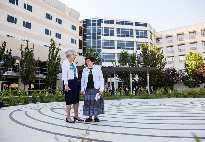 Sisters walking in the outdoor labyrinth